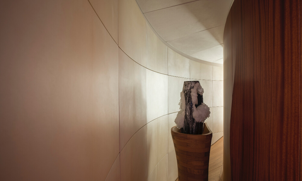 Curved walls - after Contemporary hallway with curved neutral-toned walls, sculptural decor, and ambient lighting, showcasing sleek interior design using marine panel fasteners.